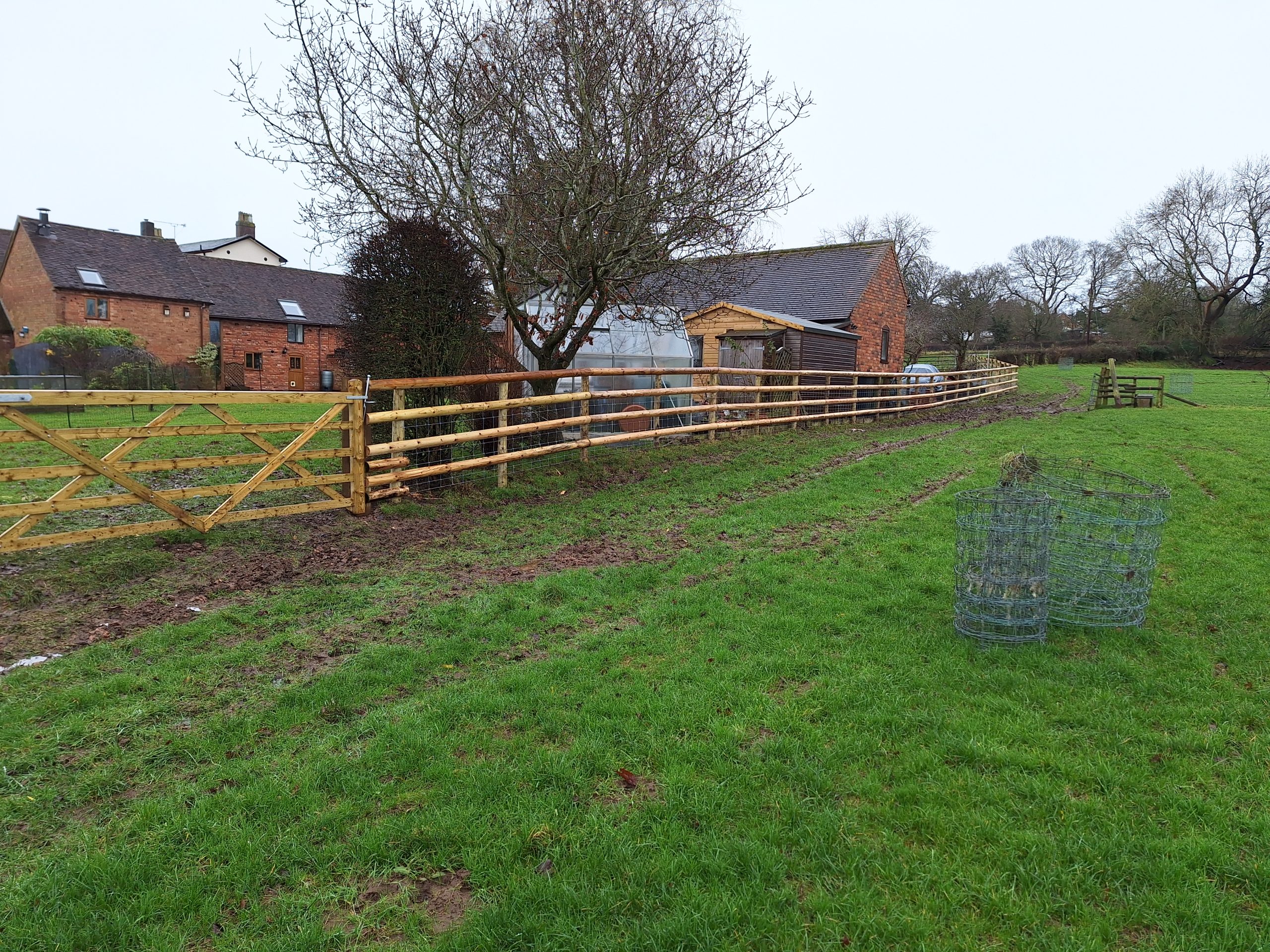 Post and rail fencing across open grassland, agricultural fencing Worcestershire