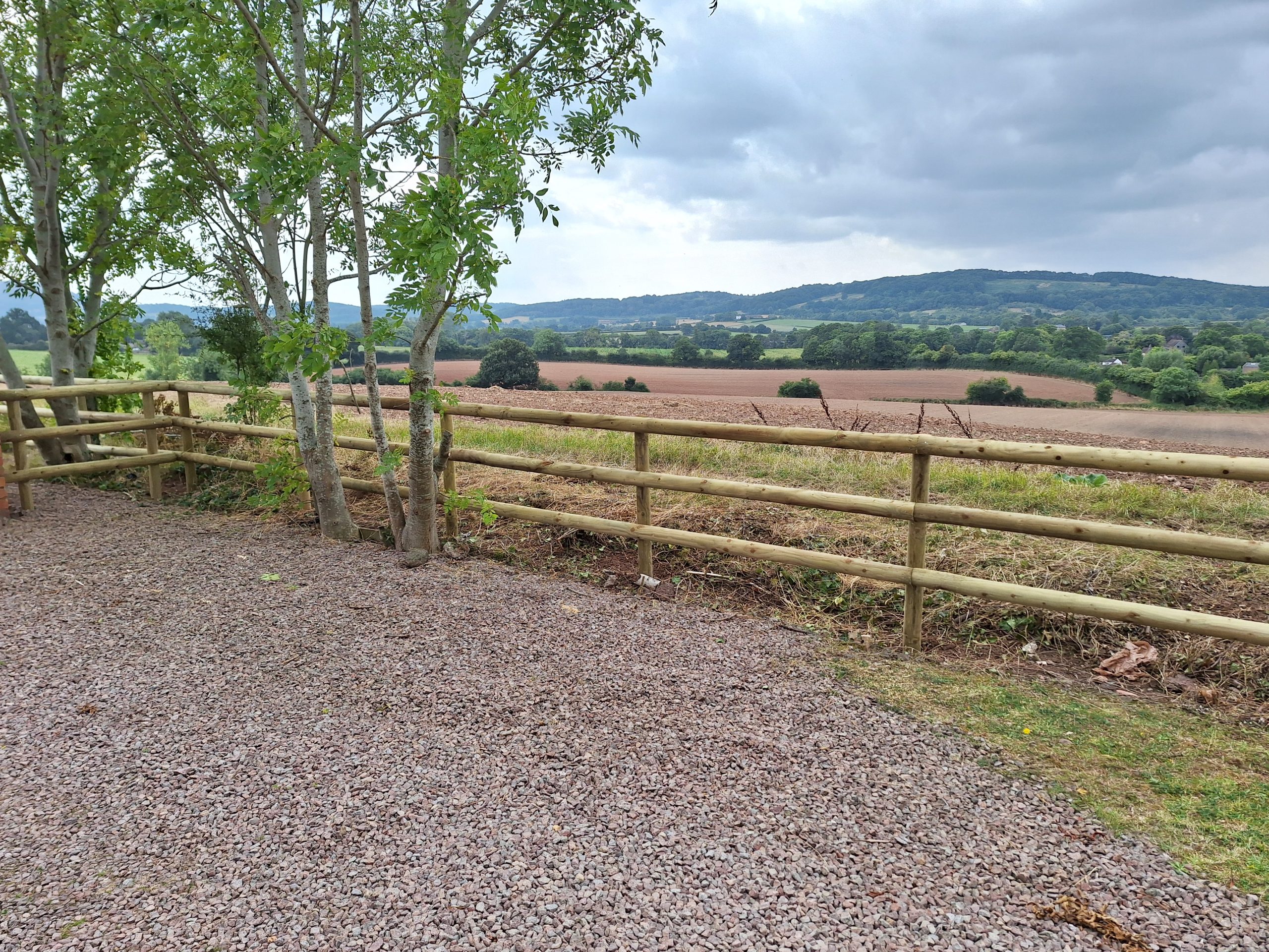 Post and rail equestrian fencing with Malvern Hills backdrop, Worcestershire