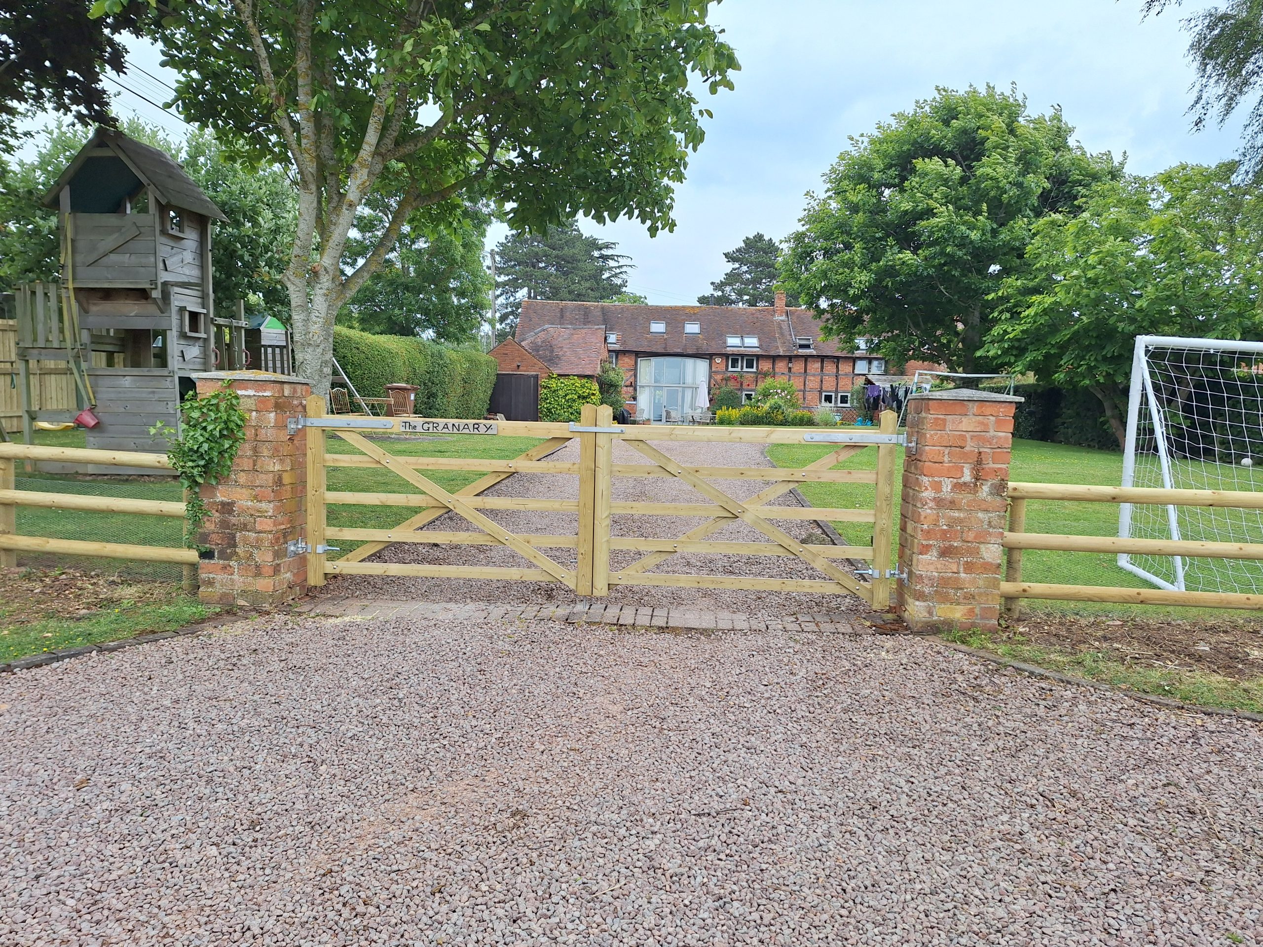 Five-bar gate with brick pillars at rural equestrian property