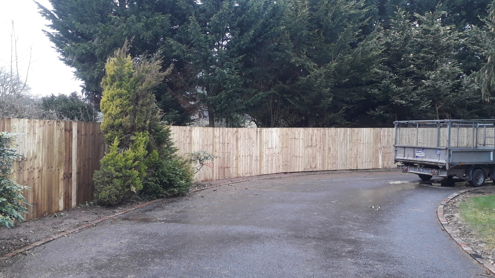Close board fence driveway installation